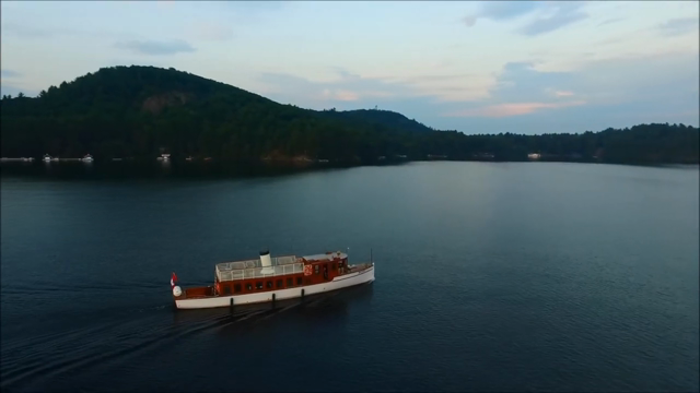 The SS Bigwin cruising at dusk — an aerial view over Lake of Bays