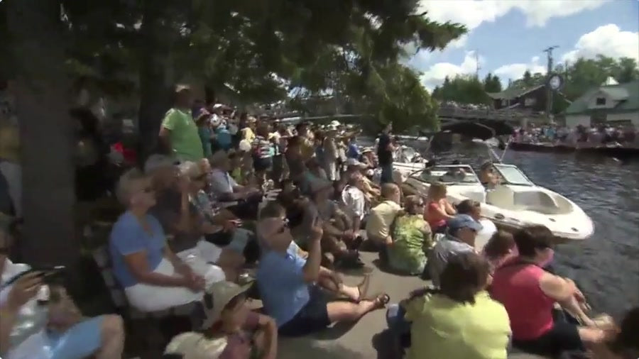 The community gathers — crowds line the shore to watch the SS Bigwin sail again